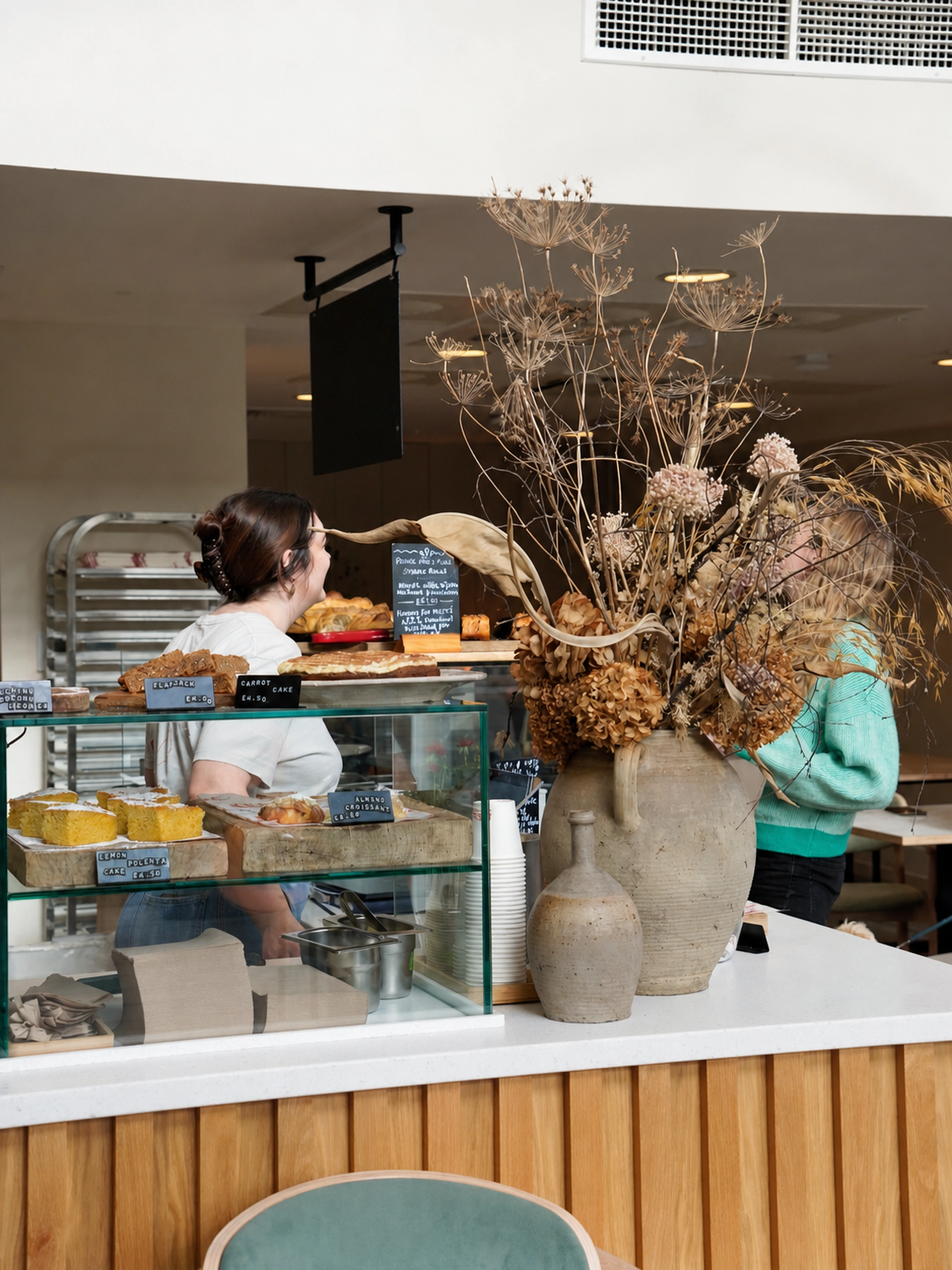 The BRaC. counter with pastries, cakes and flowers